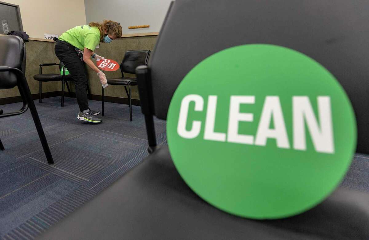 Volunteer Eileen Gaughran cleans chairs at WellMed’s Elvira Cisneros Senior Center vaccination clinic on Friday, March 26, 2021. Volunteering at vaccine clinics, often for non-clinical duties, is one way to ethically move up the line to get vaccinated against COVID-19.