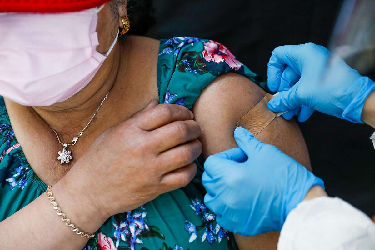 Saroeun Sim gets a bandaid over the spot where she received the Johnson & Johnson COVID-19 vaccine on Friday, March 26, 2021 in Oakland, California.