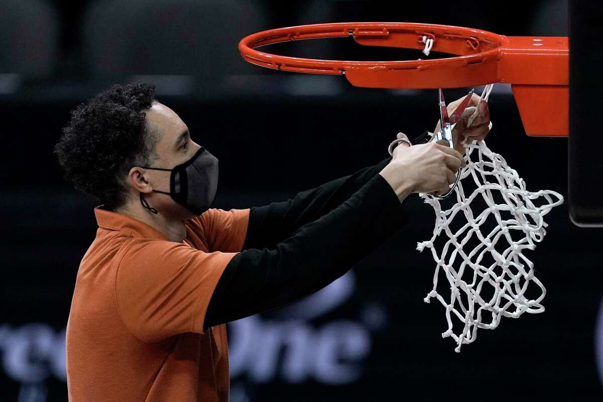 Texas head coach Shaka Smart cuts down the net after winning the Big 12 Tournament Championship NCAA college basketball game against Oklahoma State in Kansas City, Mo, Saturday, March 13, 2021. (AP Photo/Charlie Riedel)