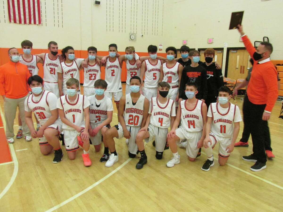 Terryville coach Mark Fowler shows his team their Berkshire League Tournament championship plaque after the Kangaroos’ win over Shepaug Friday night at Terryville High School.