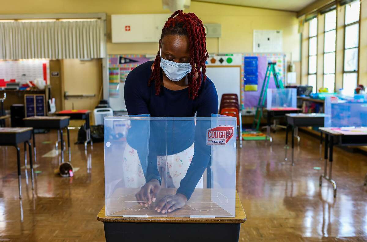 Teacher Shaione Simmons builds a “cough box” as she prepares her classroom at Madison Park Academy Primary in Oakland.
