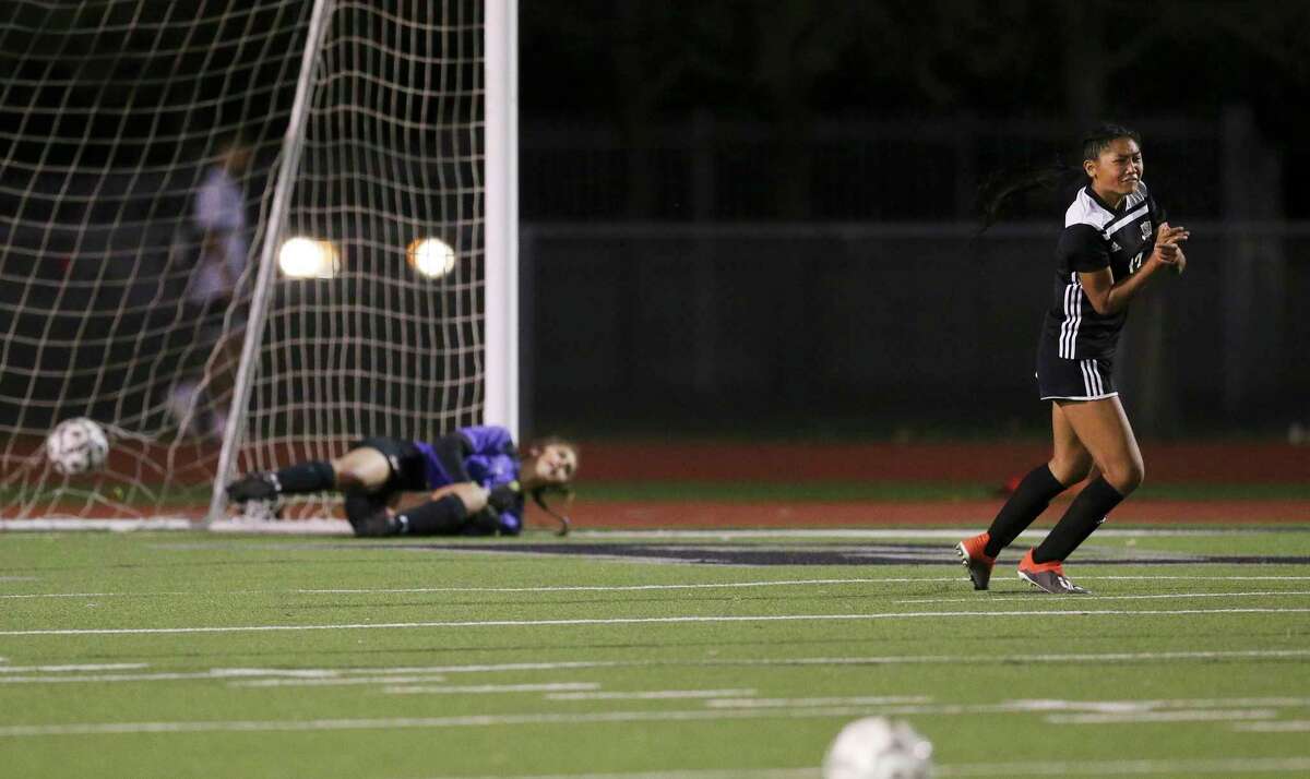 Steele's Noelani Ajel (13) reacts as she scores the deciding penalty kick against Madison goalkeeper Mia Wildeman during their Class 6A first round girls soccer playoff game at Steele High School on Friday, Mar. 26, 2021. Steele defeated Madison, 3-2, in penalty kicks after two overtime periods.