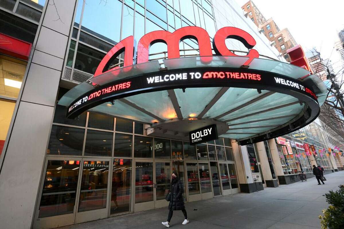 A pedestrian walks by the newly reopened AMC 34th Street theater on March 5, 2021, in New York.