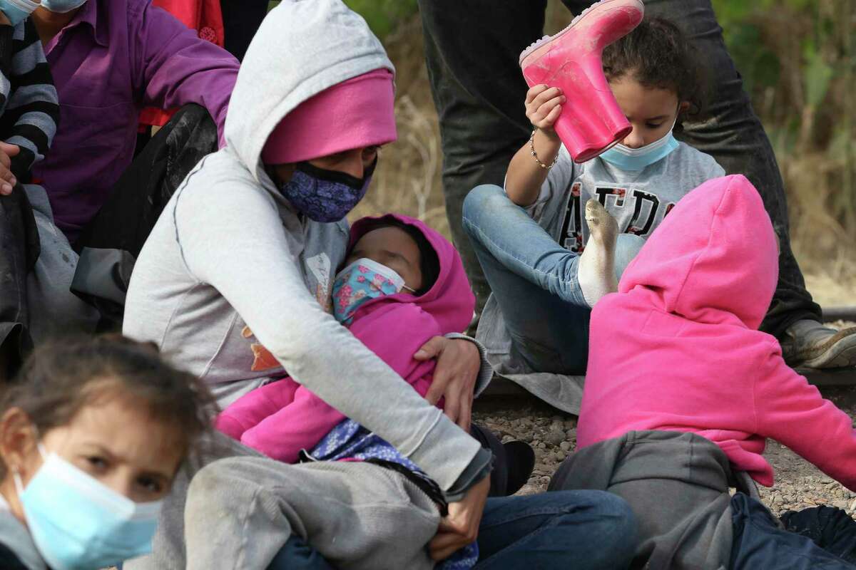 Migrant families are detained by U.S. Border Patrol agents by La Joya, Texas, Friday, March 26, 2021. The group consisted of mostly Central American migrants. In the afternoon, a group 17 Republican U.S. Senators visited the area for a tour of the Rio Grande by Anzalduas Park in Mission, Texas.