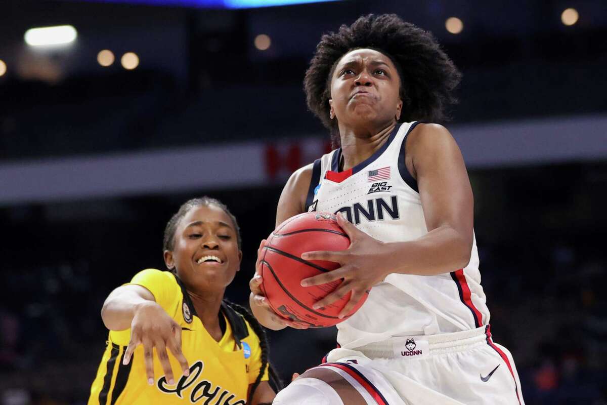 UConn’s Christyn Williams, right, drives to the basket ahead of Iowa’s Tomi Taiwo during the second half on Saturday.