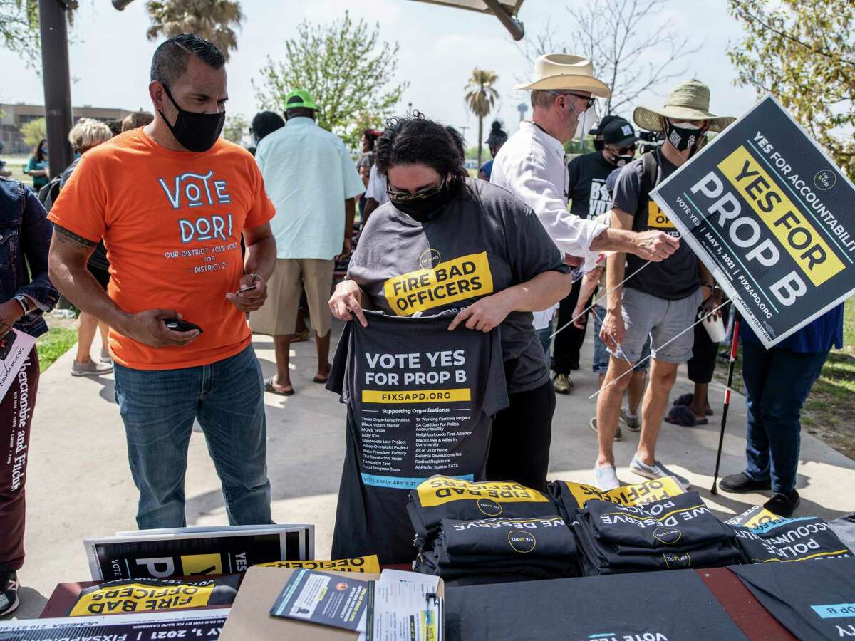 Yadira del Toro, 45, center, a volunteer with FixSAPD, sells T-shirts bearing the phrase, “Vote Yes For Prop B,” during a rally Saturday to support Proposition B, which would repeal the San Antonio police union’s ability to collectively bargain with the city. The rally drew about 200 people to Pittman-Sullivan Park.