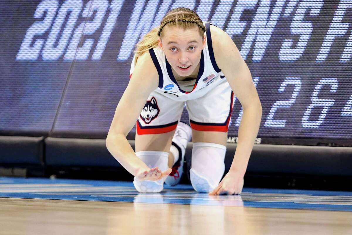 SAN ANTONIO, TEXAS - MARCH 27: Paige Bueckers #5 of the UConn Huskies cheers while waiting to enter the game against the Iowa Hawkeyes during the first half in the Sweet Sixteen round of the NCAA Women's Basketball Tournament at the Alamodome on March 27, 2021 in San Antonio, Texas. (Photo by Carmen Mandato/Getty Images)
