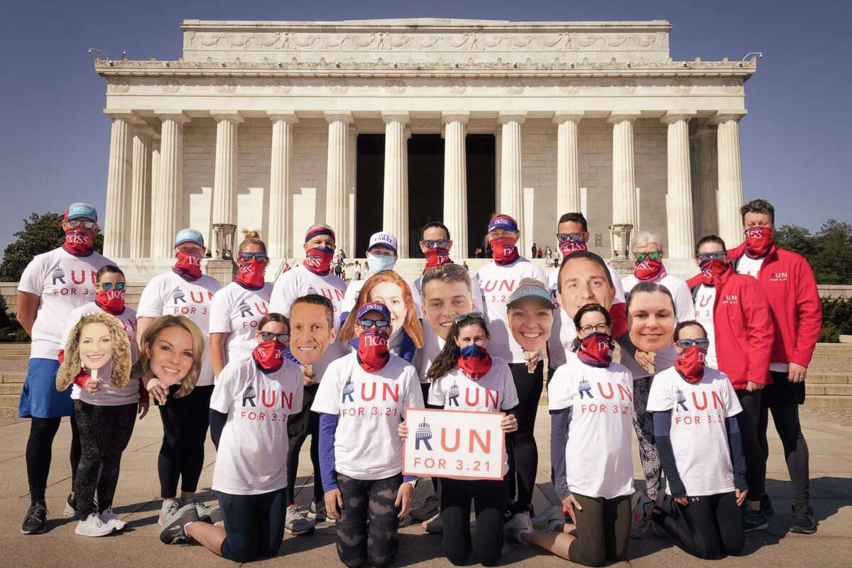 Jaime Durant of Albany, in middle holding the sign, with some of her 