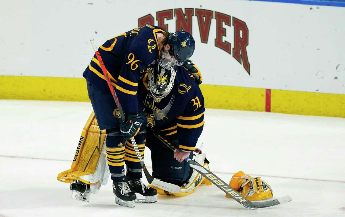 Quinnipiac forward Ty Smilanic, left, consoles goaltender Keith Petruzzelli after he gave up the winning goal to Minnesota State’s Ryan Sandelin in overtime of their NCAA West Regional semifinal game Saturday.