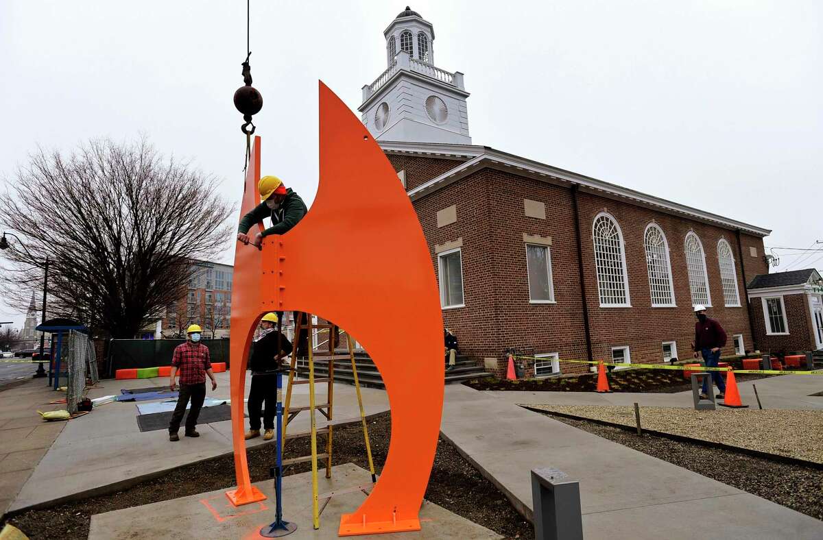 Studio emplyees of artist Gilbert Boro install a 16-foot steel sculpture, ATR (After The Race) in the front sculpture garden of the new Norwalk Art Space Friday, March 26, 2021, in Norwalk, Conn. The free arts hub is also hosting a meet and greet Saturday with its resident artists, fellows and team members as they prepare to open in the coming months.