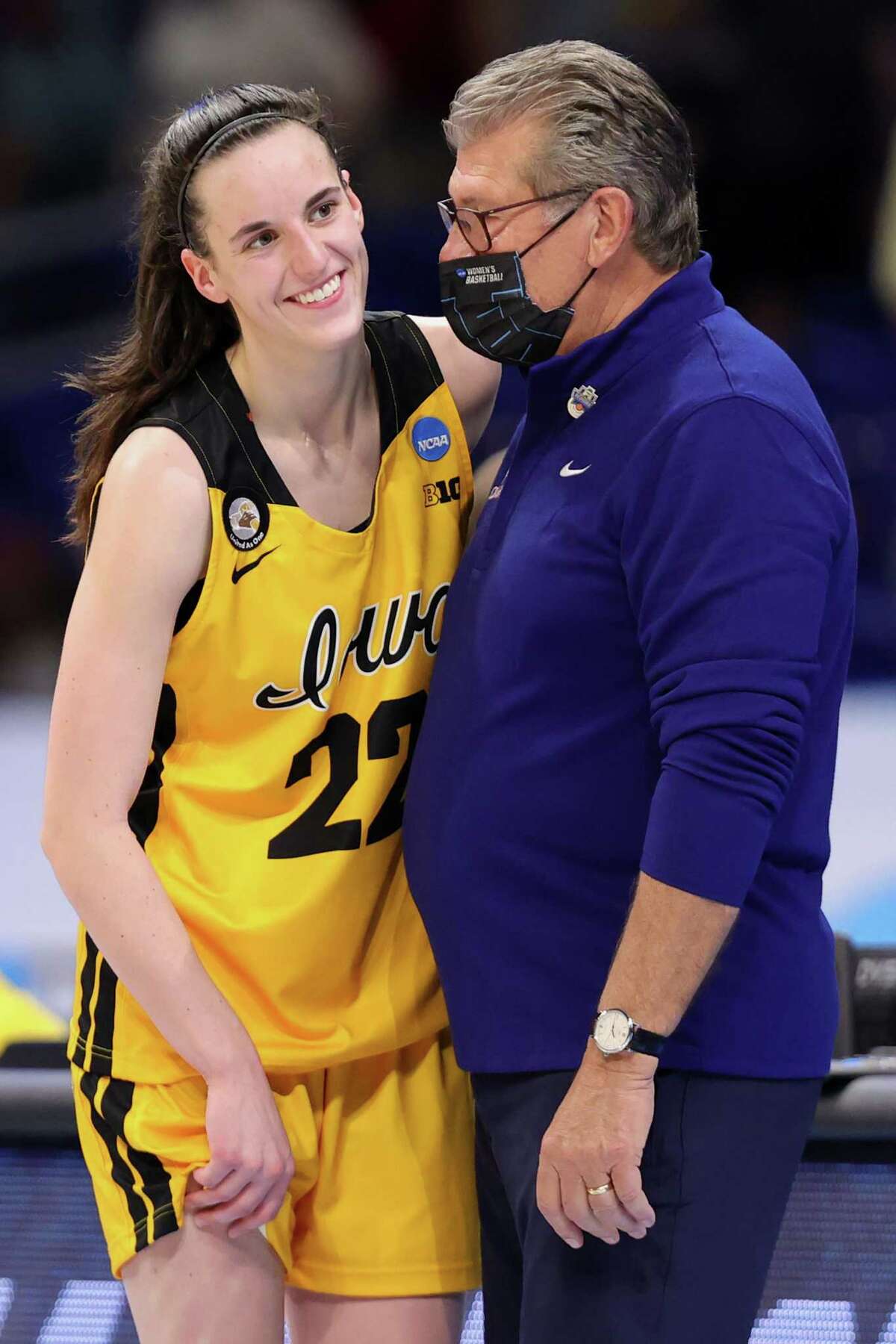 SAN ANTONIO, TEXAS - MARCH 27: Head coach Geno Auriemma of the UConn Huskies speaks with Caitlin Clark #22 of the Iowa Hawkeyes following their 92-72 win in the Sweet Sixteen round of the NCAA Women's Basketball Tournament at the Alamodome on March 27, 2021 in San Antonio, Texas. (Photo by Carmen Mandato/Getty Images)