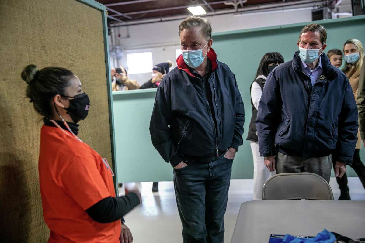 STAMFORD, CONNECTICUT - MARCH 14: CT Governor Ned Lamont (D-CT) (C), and Senator Richard Blumenthal (D-CT) (R), speak with a volunteer at a community vaccination clinic on March 14, 2021 in Stamford, Connecticut. The non-profit Building One Community organized the event to administer the first dose of the Moderna vaccine to more than 350 people from the immigrant and undocumented communities. The vaccines were supplied by the federal Health Resources and Services Administration (HRSA). Vaccine recipients are due to return in April for their second dose. (Photo by John Moore/Getty Images)