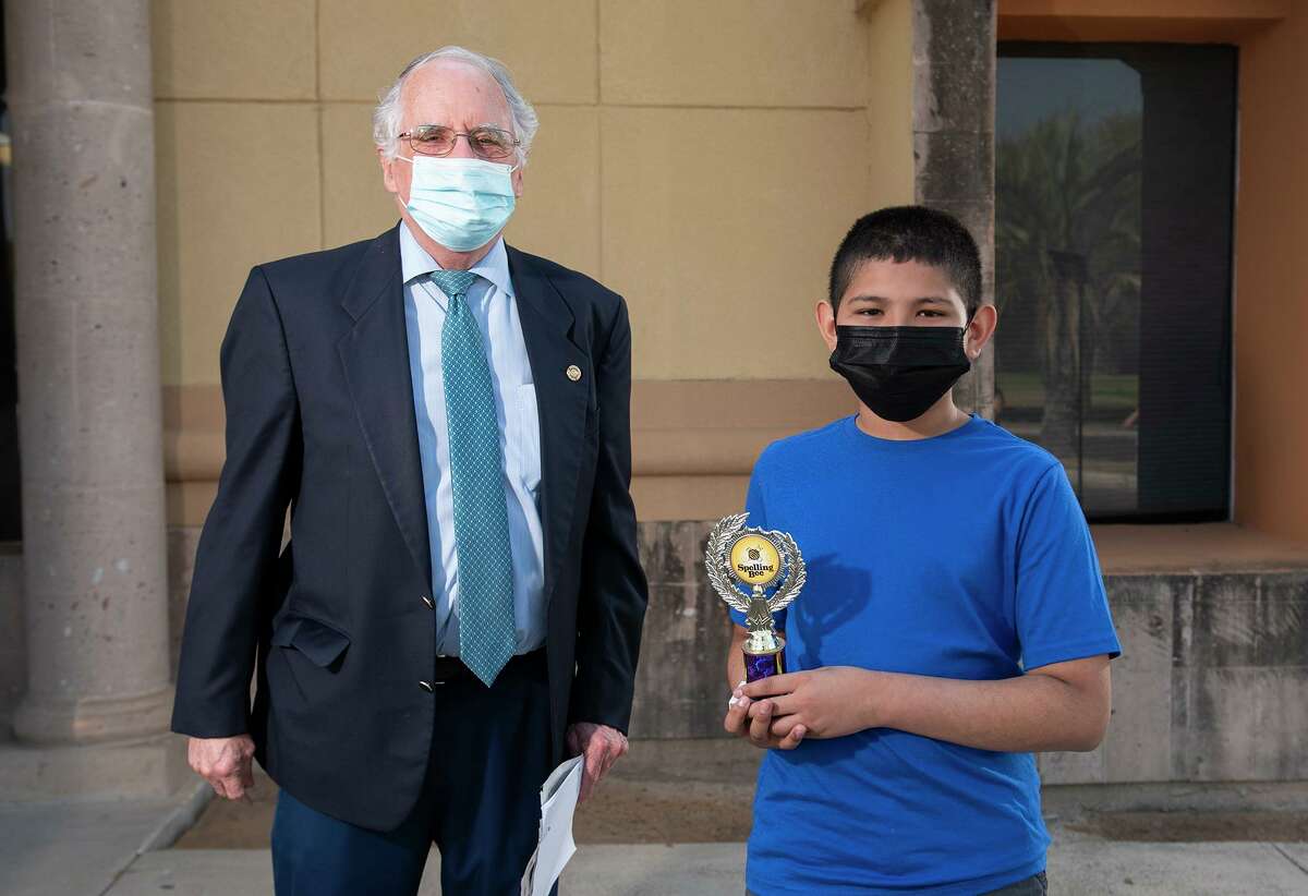 Laredo Morning Times Publisher Bill Green presents Tarver Elementary 5th grader Alfredo Vasquez with his fourth-place trophy Saturday, March 27, 2021 outside Laredo Morning Times.