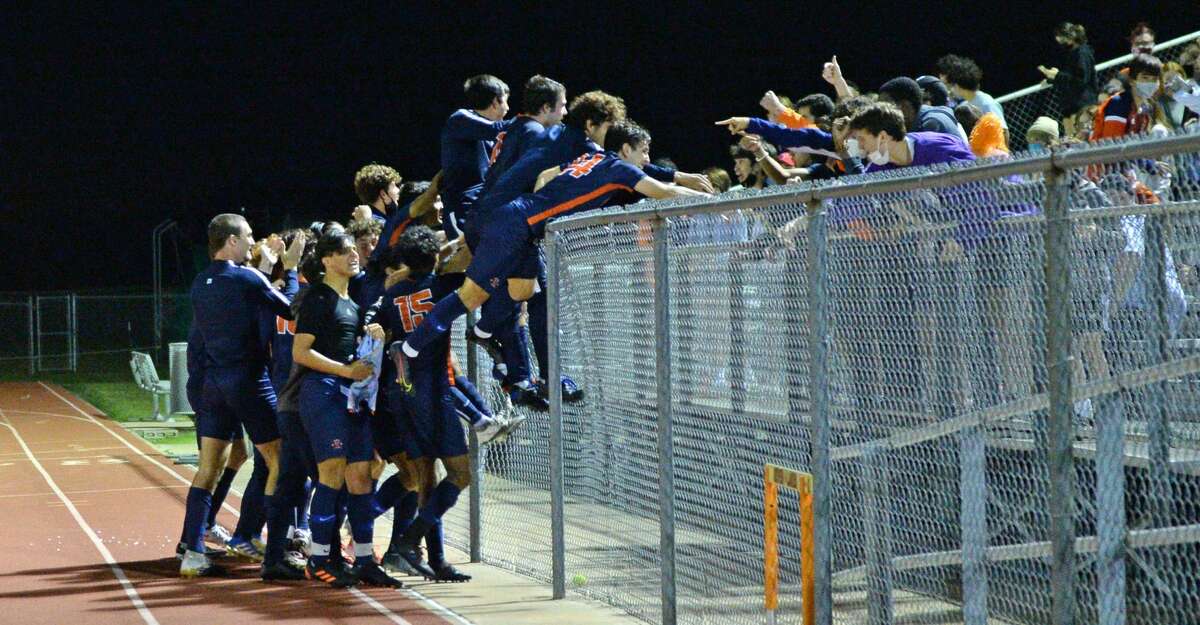 The Seven Lakes Spartans celebrate with their fans following their 2-1 victory over the Cinco Ranch Cougars in the 6A-III District 19 Championship soccer match on Friday, March 12, 2021 at Seven Lakes HS, Katy, TX.