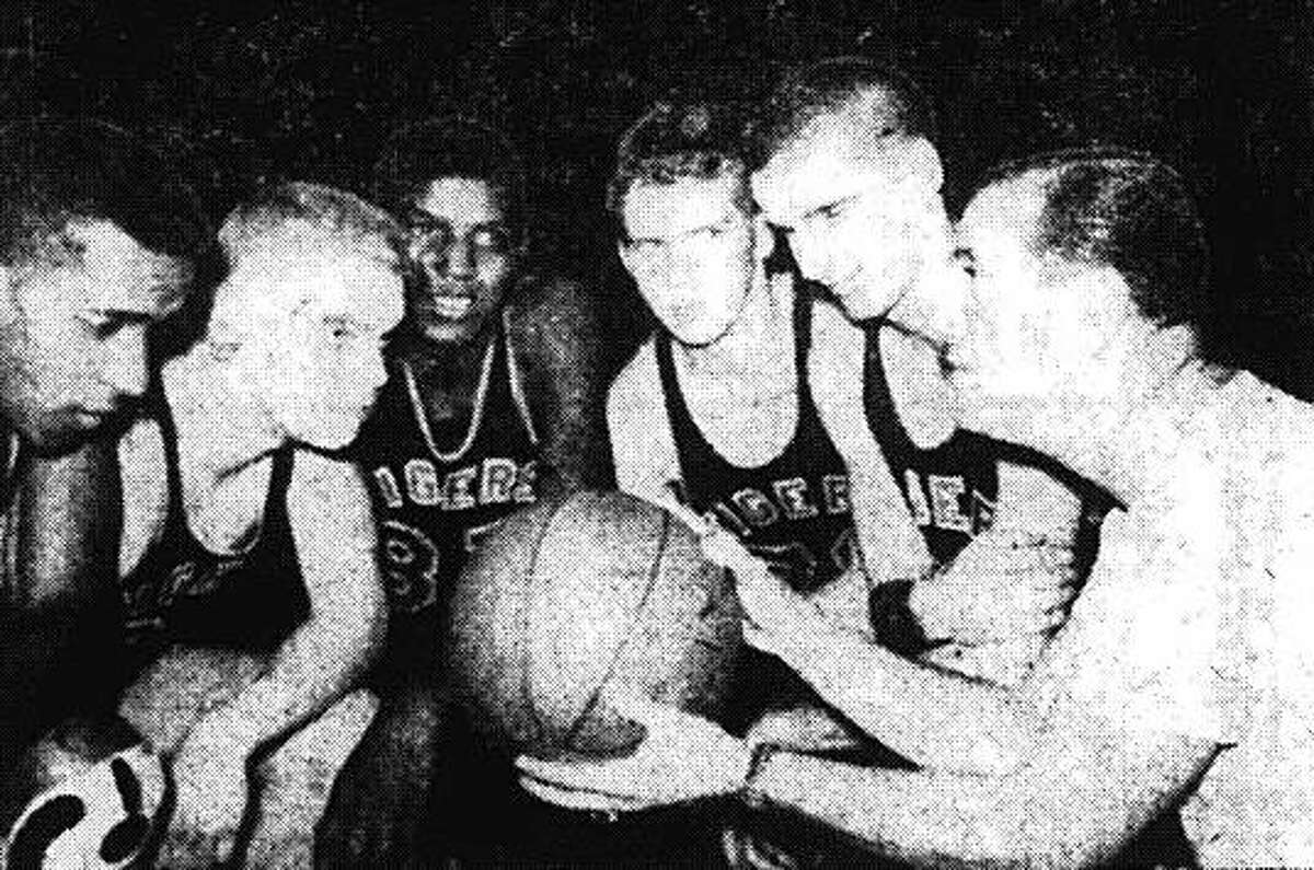 Edwardsville coach Joe Lucco, right, talks strategy with EHS starters, left to right, Mannie Jackson, Buzz Shaw, Govoner Vaughn, Harold Patton and Jimmy Chandler before a game during the 1955-56 season.