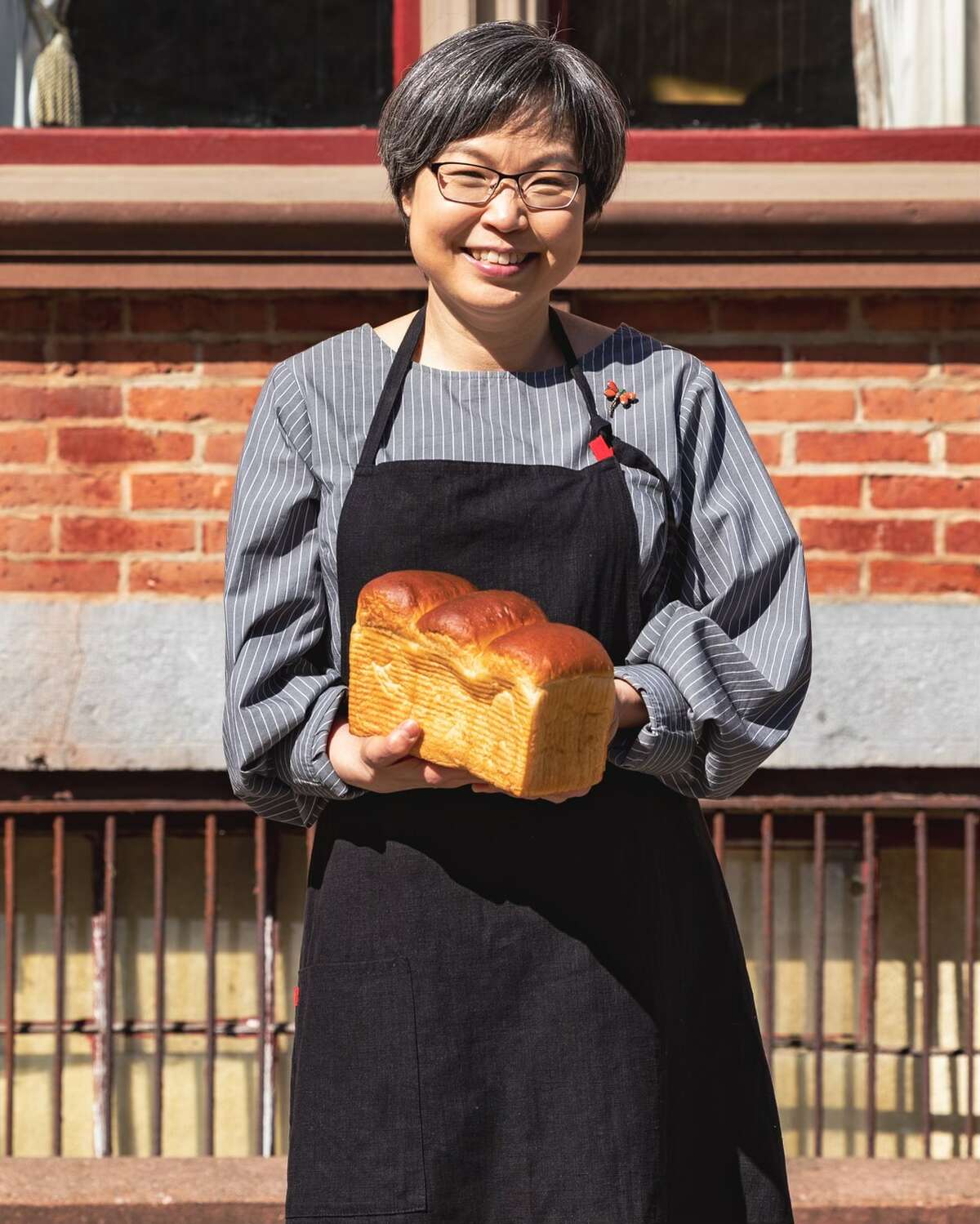 Sookyung Lee, owner of Ppang Bakery, with a loaf of milk bread.
