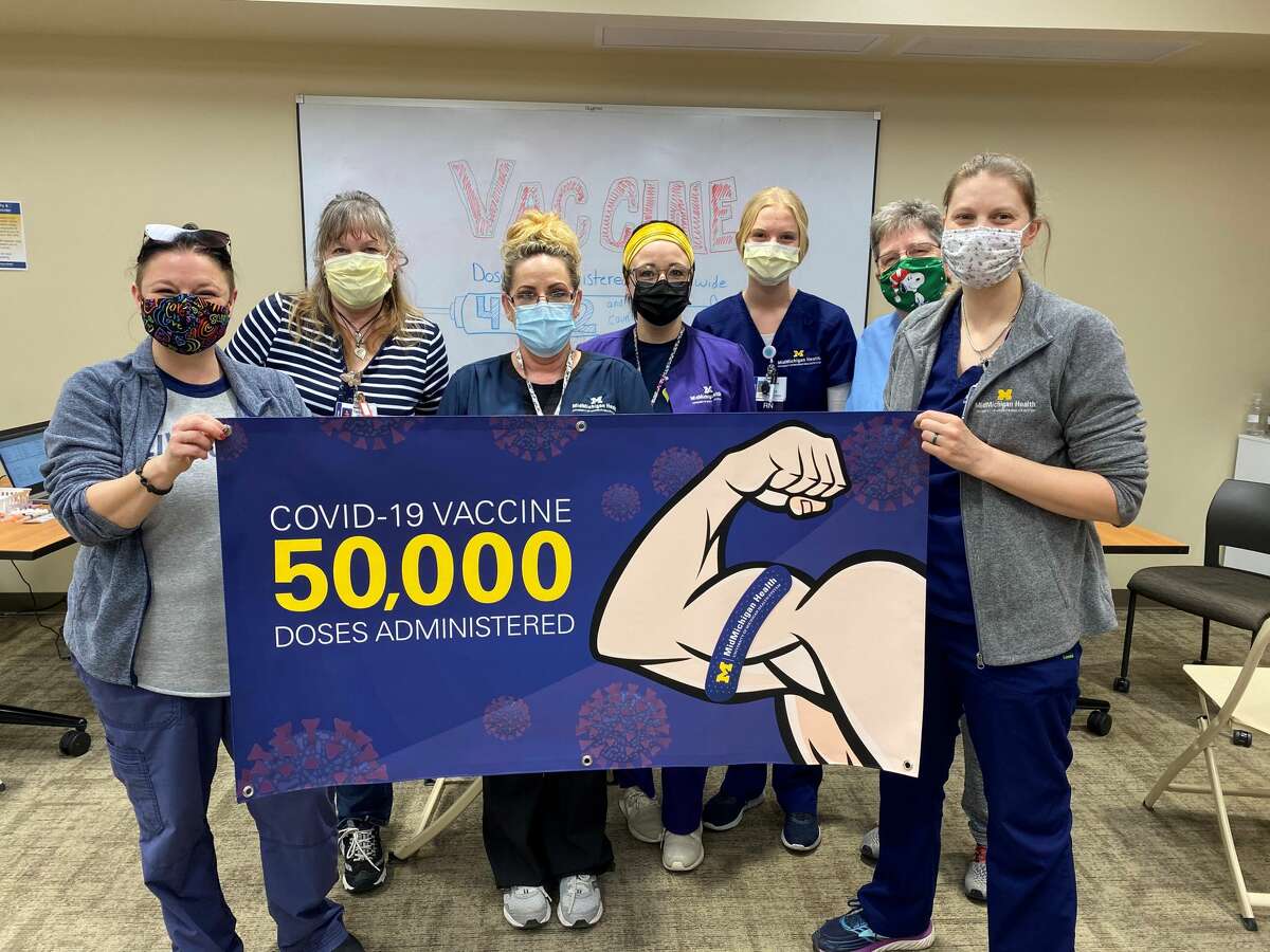 MidMichigan Health employees celebrate having recently given the health system's 50,000th dose of COVID-19 vaccine. (Photo provided/Jackie Keyser)