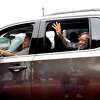 Carolyn Guidry waves and shouts as a long parade of cars make their way up Crockett Street Sunday in a community celebration of her retirement. Photo made Sunday, March 28, 2021 Kim Brent/The Enterprise