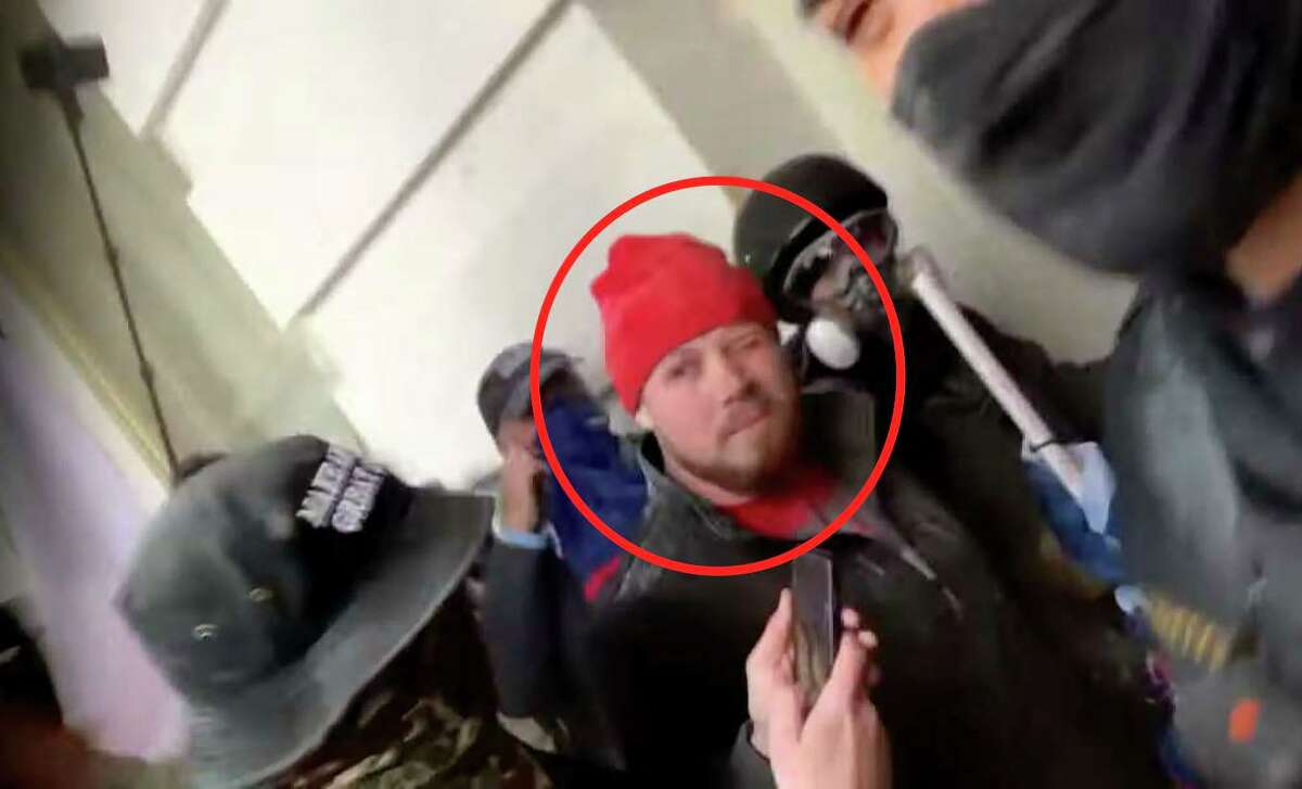 A witness told the FBI the man pictured in the read beanie during the Capitol riot was Christian Cortez. Cortez later identified himself as the man captured in the Jan. 6 footage, according to court documents.