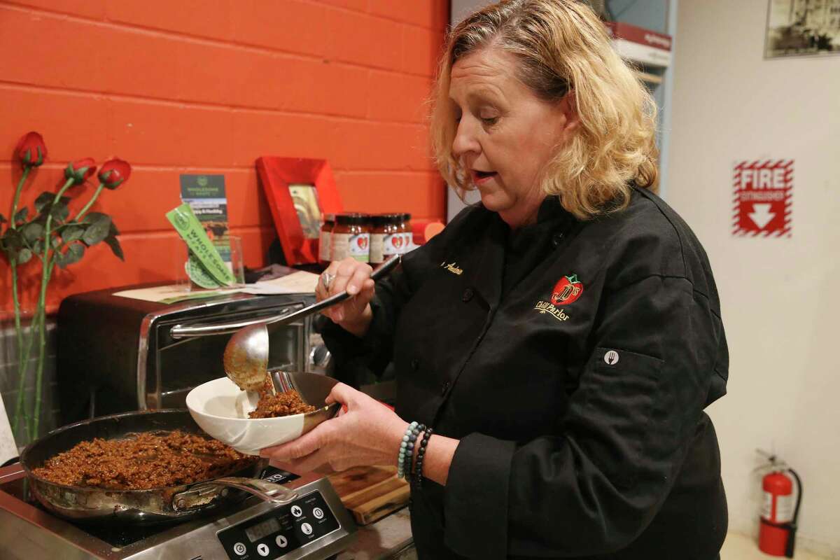 Diana Anderson, of JD’s Chili Parlor, serves a bowl of chili at their kitchen in the Local Sprout Food Hub.