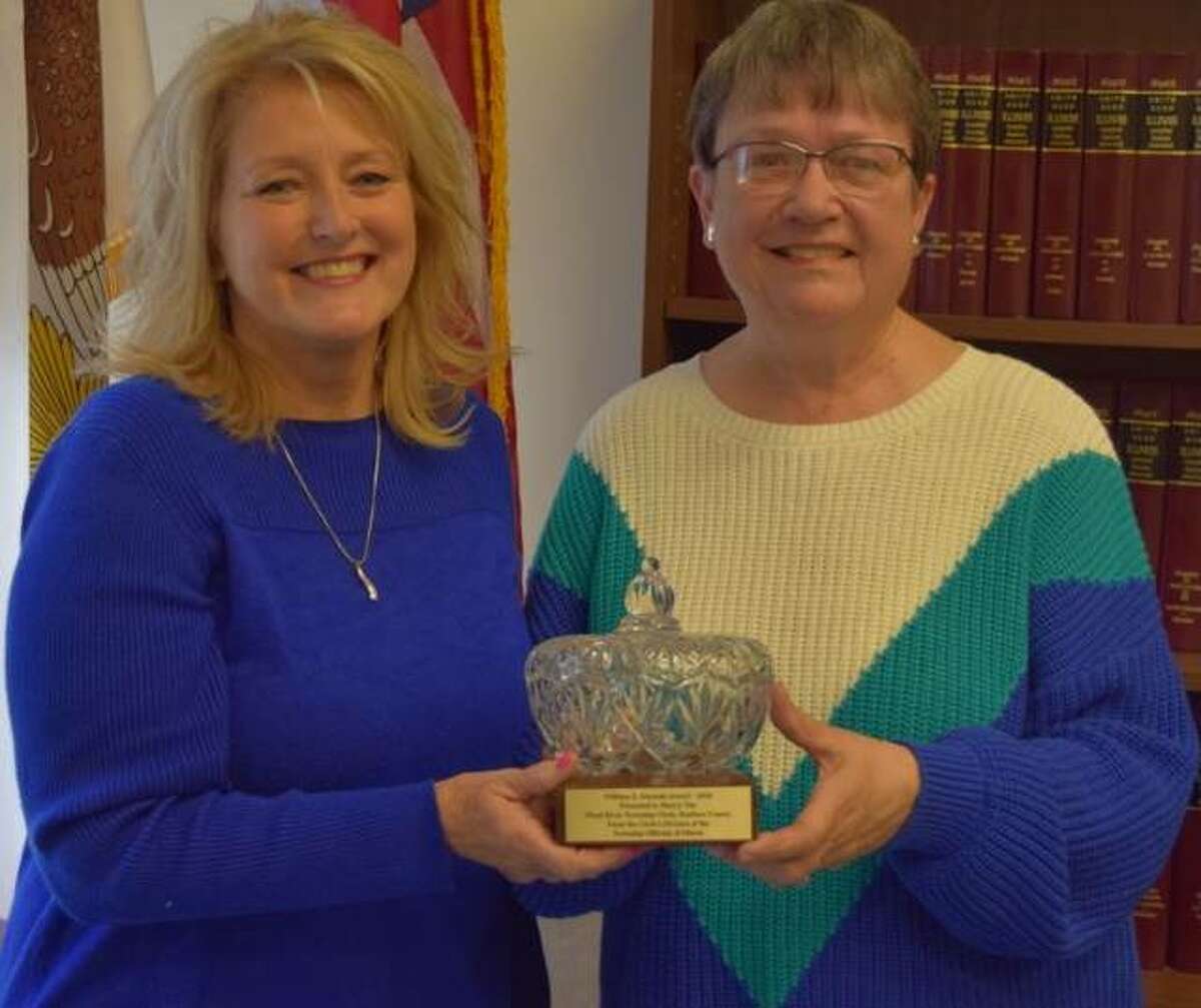 Wood River Township Clerk Sherry Tite, left, receives the 2020 William Z. Ahrends Award from Cass Township Clerk Jeanette McWhorter.