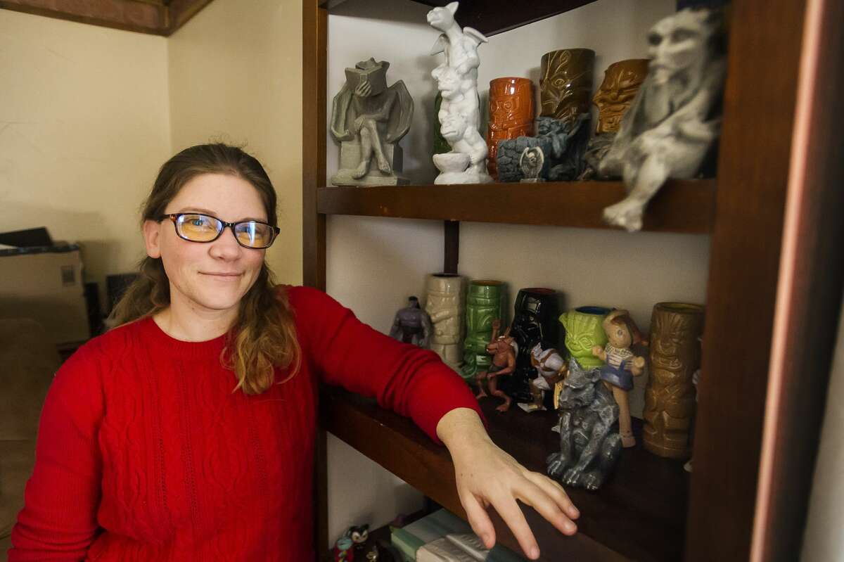 Cindy Trombley poses for a portrait alongside several of the gargoyles included in her collection, Tuesday, Feb. 16, 2021 at her home in Midland. (Katy Kildee/kkildee@mdn.net)