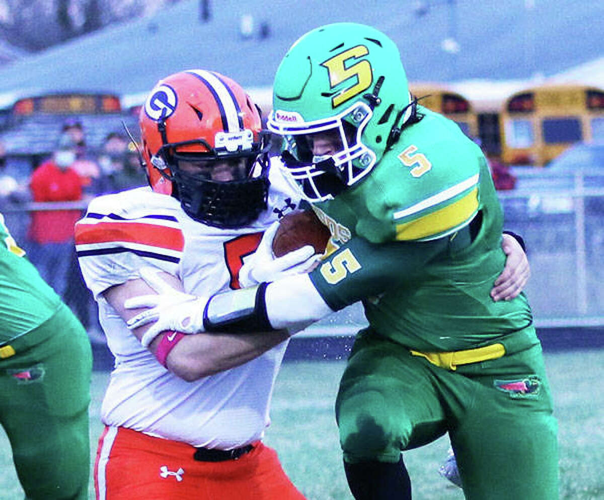 Southwestern RB Gavin Day (5) is hit by Gillespie LB Zane Cunningham in their SCC football game Friday night in Piasa.