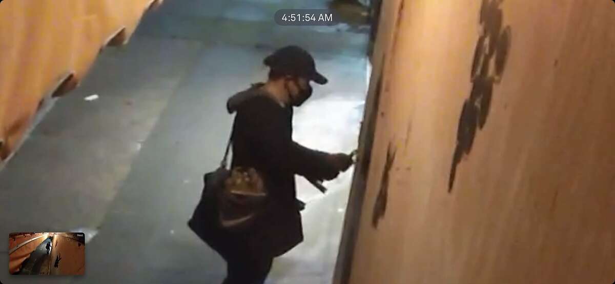 Security footage from Biondivino, a wine shop in S.F., shows a person attempting to break in on March 18 using a crowbar.