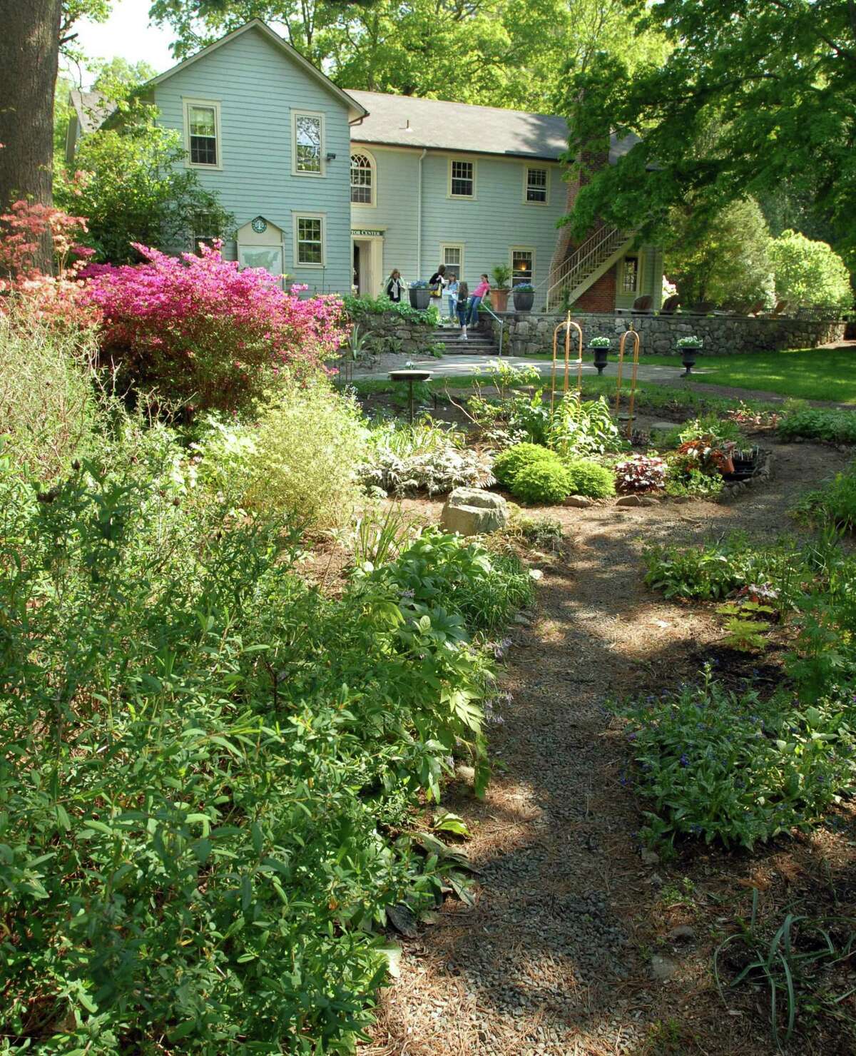 The cottage garden in front of the visitor center at Bartlett Arboretum and Gardens is full of blooming flowers.