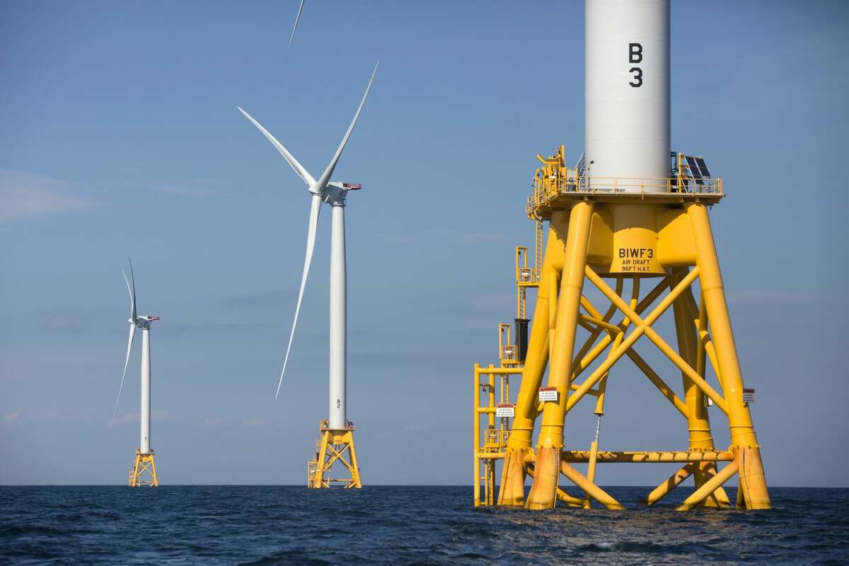 FILE - In this Monday, Aug. 15, 2016, file photo, three of Deepwater Wind's turbines stand in the water off Block Island, R.I. A huge wind farm off the Massachusetts coast is edging closer to federal approval, setting up what the Biden administration hopes will be a model for a sharp increase in offshore wind energy development along the East Coast.(AP Photo/Michael Dwyer, File)