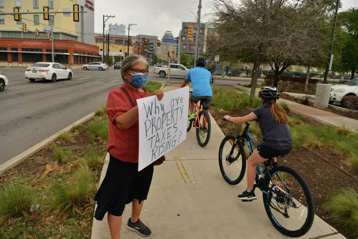 Rebecca Flores holds a sign during a protest Saturday in downtown San Antonio.