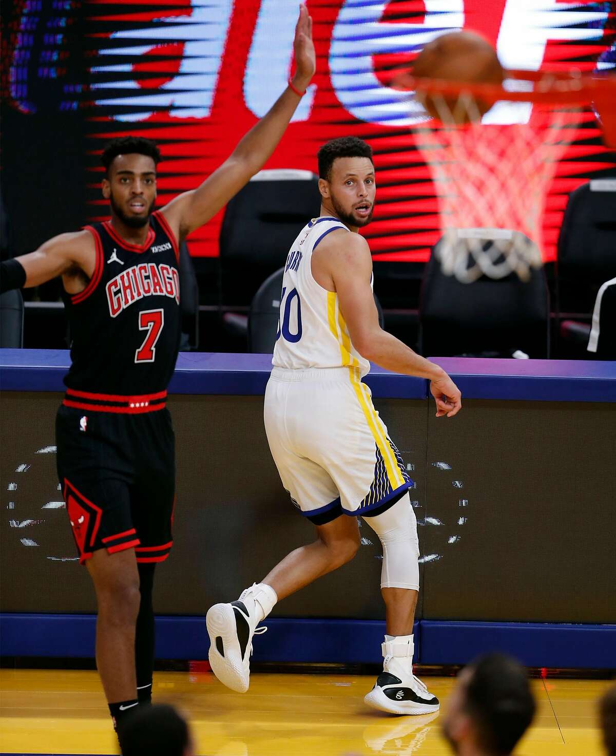 Curry and Chicago’s Troy Brown Jr. watch the Warrior’s 3-pointer go in at Chase Center in San Francisco.during 2nd quarter of NBA game at Chase Center in San Francisco, Calif., on Monday, March 29, 2021,