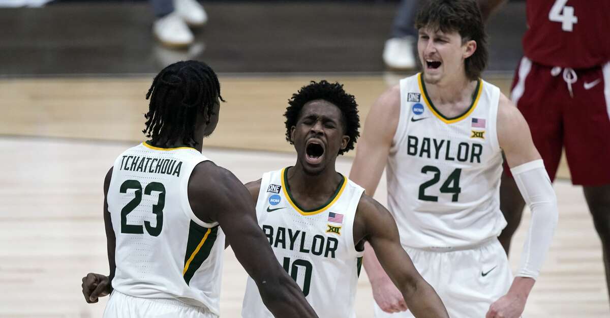 Baylor guard Adam Flagler (10), Jonathan Tchamwa Tchatchoua (23) and Matthew Mayer (24) celebrate a play against Arkansas during the second half of an Elite 8 game in the NCAA men's college basketball tournament at Lucas Oil Stadium, Monday, March 29, 2021, in Indianapolis. (AP Photo/Michael Conroy)