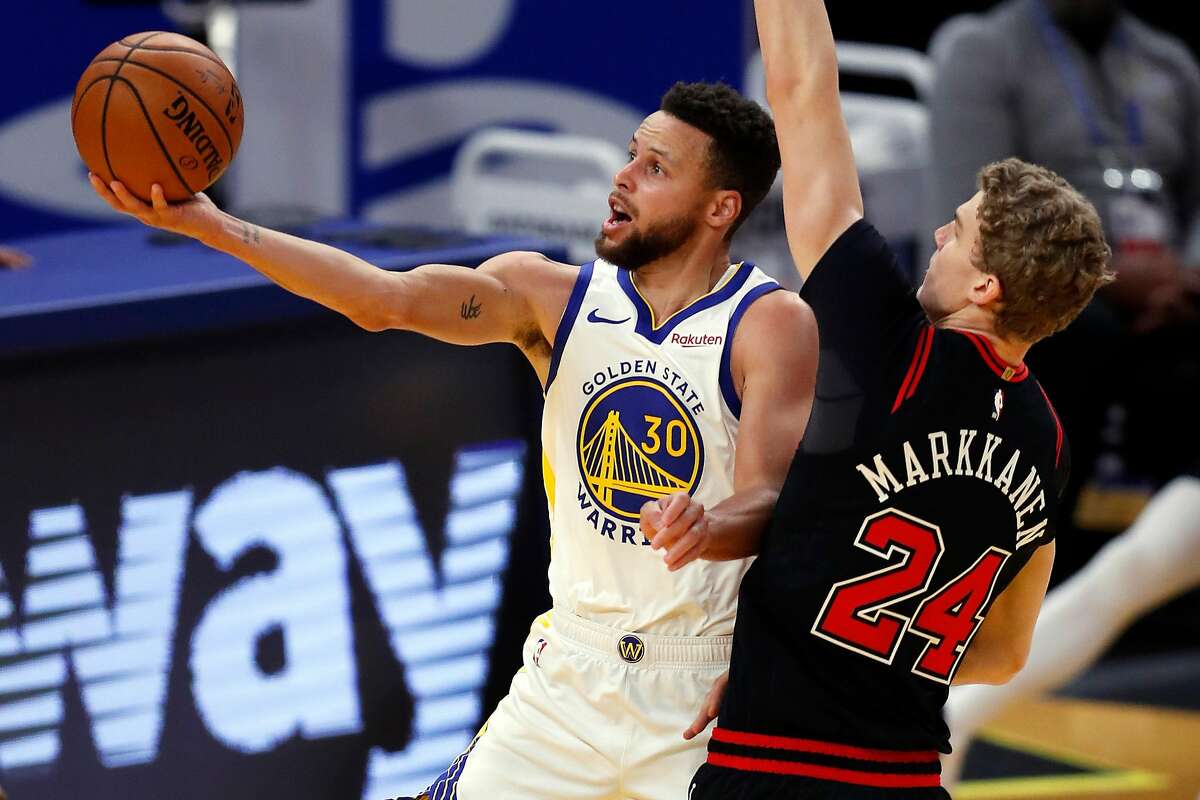 Golden State Warriors' Stephen Curry scores against Chicago Bulls' Lauri Markkanen during 3rd quarter of NBA game at Chase Center in San Francisco, Calif., on Monday, March 29, 2021,