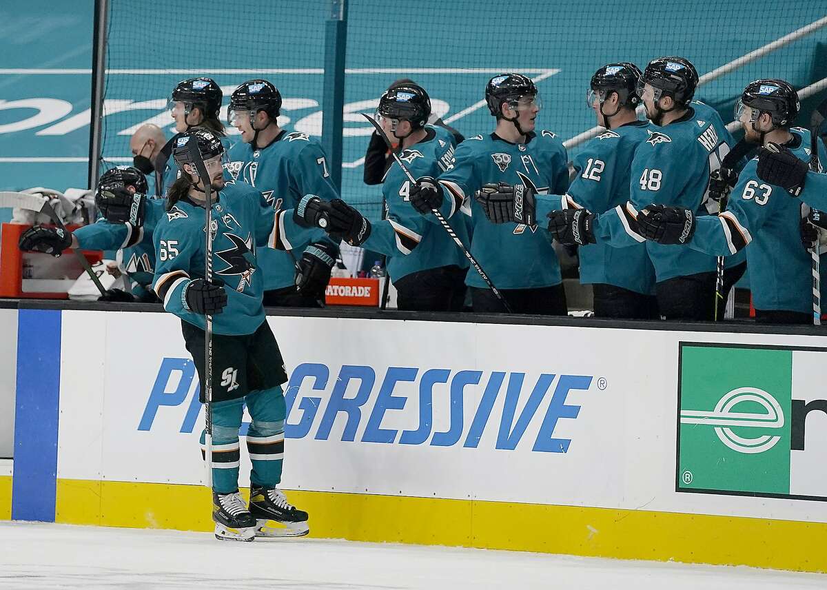 Sharks defenseman Erik Karlsson is congratulated by the bench after scoring in the second period against Minnesota.