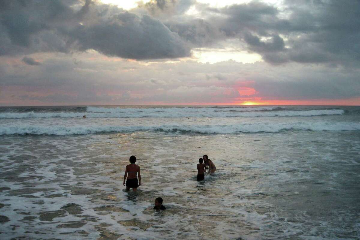 A travel executive says travel deals can be had in 2021 in Costa Rica and similar markets because summer, with increasing heat and hurricanes, is typically their low season. Beachgoers are photographed in the Pacific Ocean in Playa Guiones, Nosara, Costa Rica, on Dec. 26, 2007.