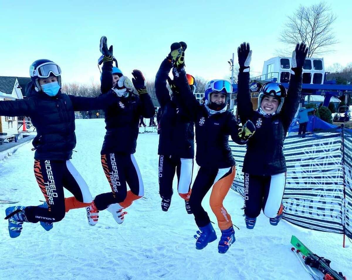 Members of the Ridgefield High School girls' ski team jumped for joy after clinching the state championships.