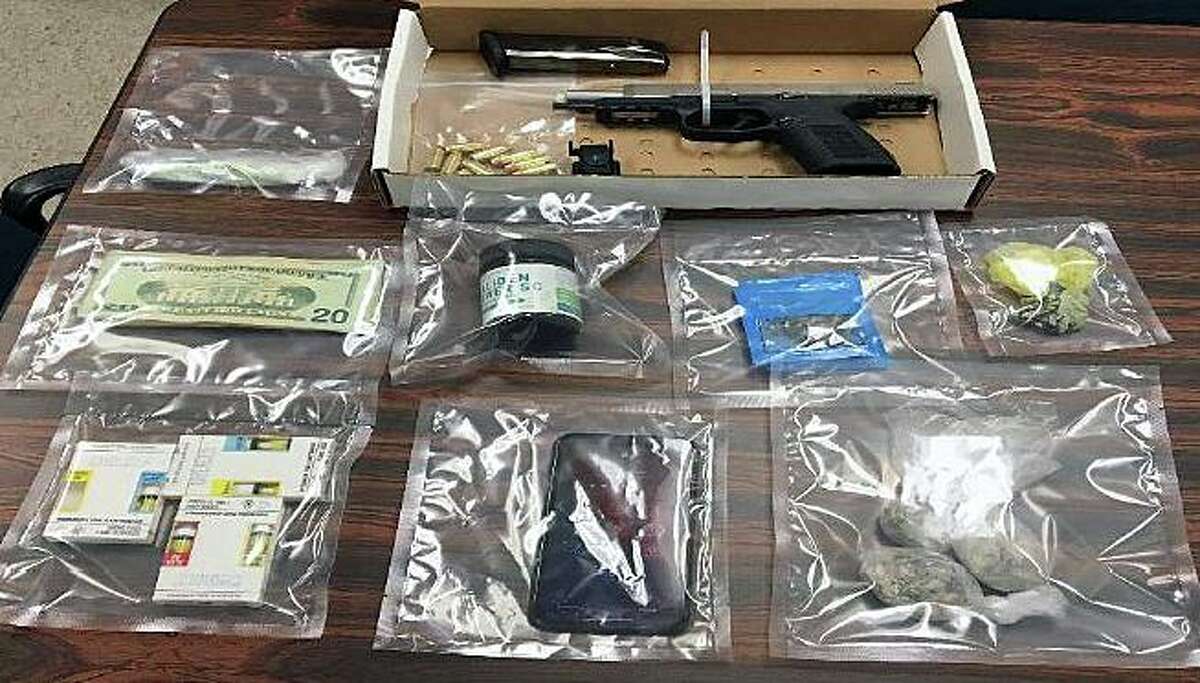 Investigators seized a stolen semi-automatic gun with a laser sight and a high-capacity magazine loaded with live ammunition, 97 Xanax pills, 40 grams of marijuana, 36 grams of psychedelic mushrooms and a small amount of cash.