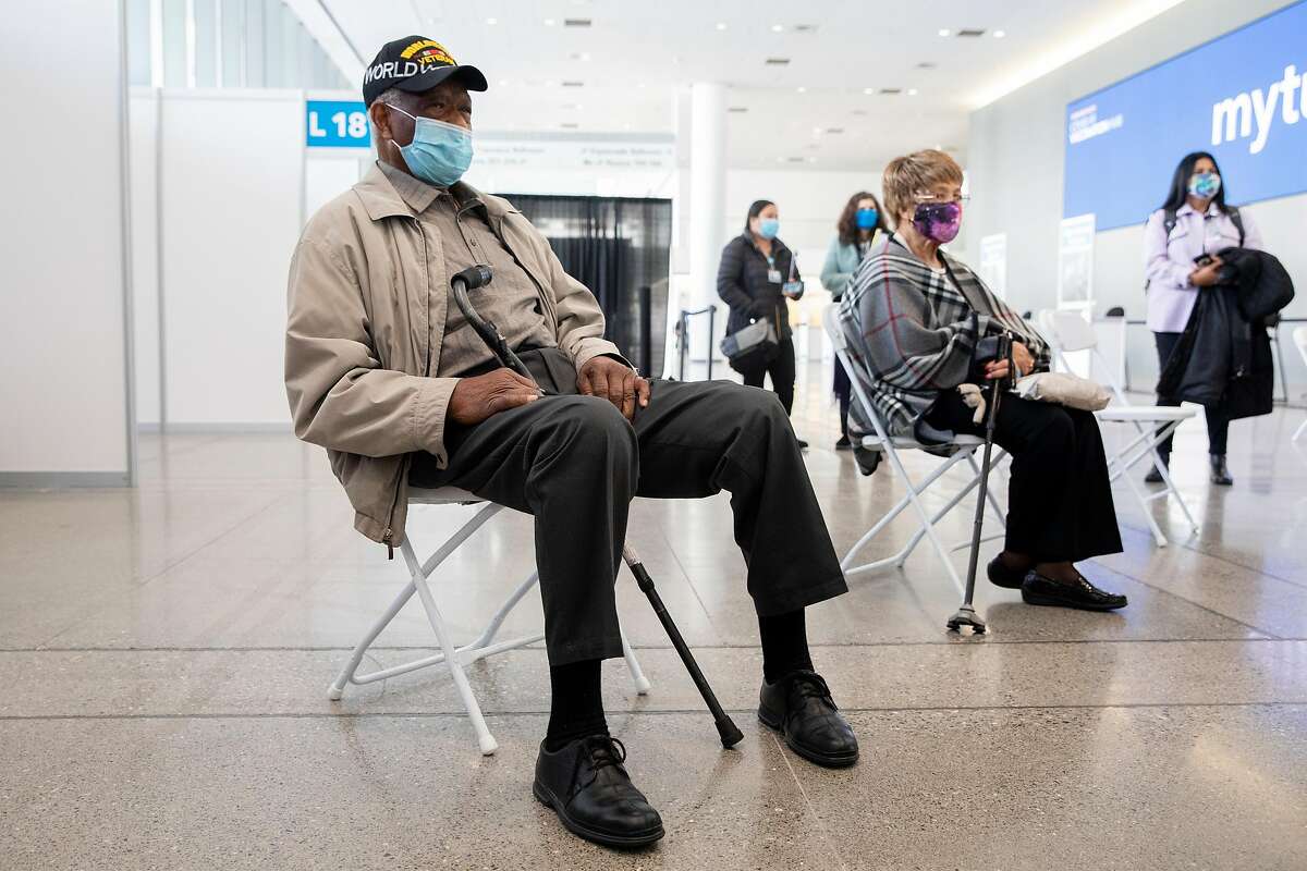 Ezekiel Logan, a 96-year-old World War II veteran, waits to receive his first dose of the Pfizer COVID-19 vaccine ahead of the grand opening of a mass COVID-19 vaccination site at Moscone South in San Francisco, Calif. Thursday, February 4, 2021. 