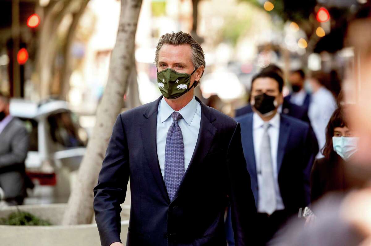 Gov. Gavin Newsom leaves a news conference in San Francisco Wednesday. A new poll indicates Newsom would prevail in a recall election if it were held today.