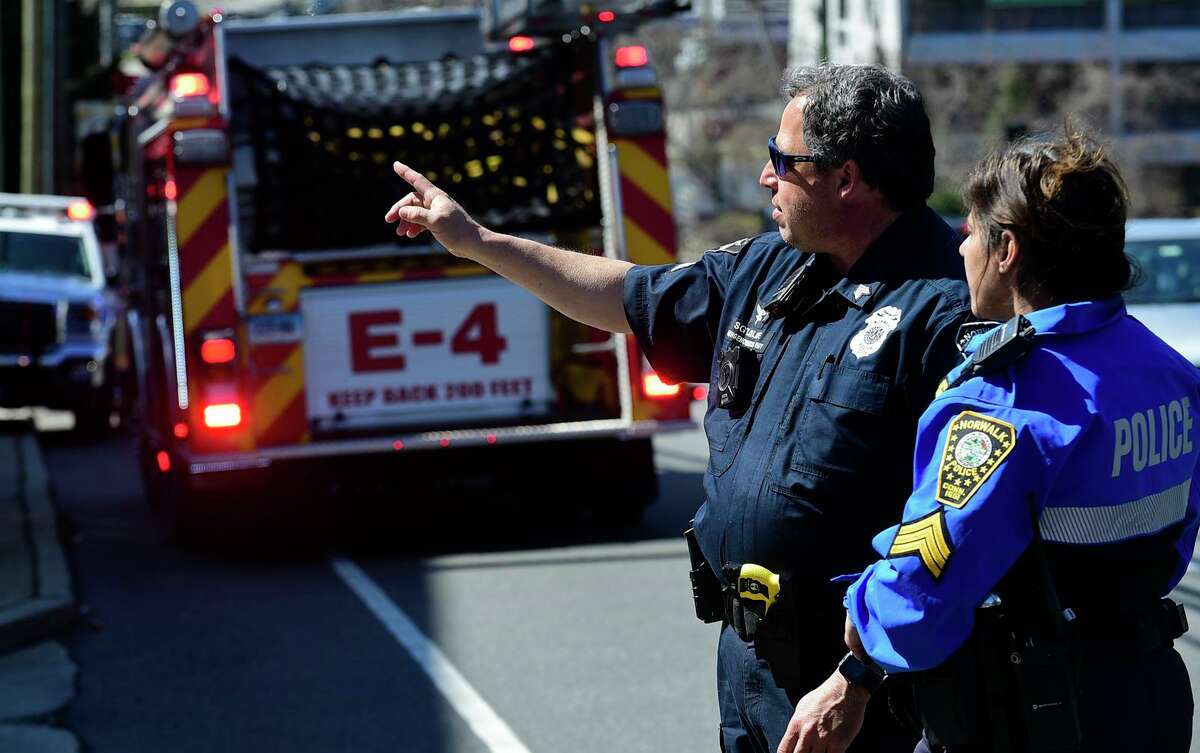 Norwalk emergency personnel respond to the scene of a single motor vehicle accident Tuesday March 30, 2021, where a car rolled over on Westport Ave near the intersection at East Ave. in Norwalk, Conn.