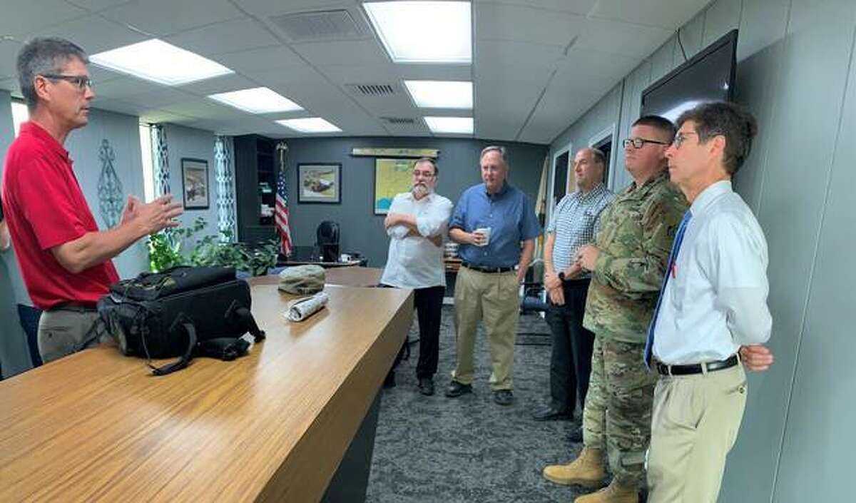 In this August 2019 file photo, Hal Graef, project manager with the U.S. Army Corps of Engineers St. Louis District, presents information to Wood River Drainage and Levee District President Ron Carnell, Metro East Sanitary District Director Stephen Adler, Southwestern Illinois Flood Prevention District Chief supervisor Chuck Etwert, U.S. Army Col. Bryan K. Sizemore, commander of the St. Louis District and Madison County Board Chairman Kurt Prenzler on the new partnership agreement for the Wood River Levee System reconstruction project.