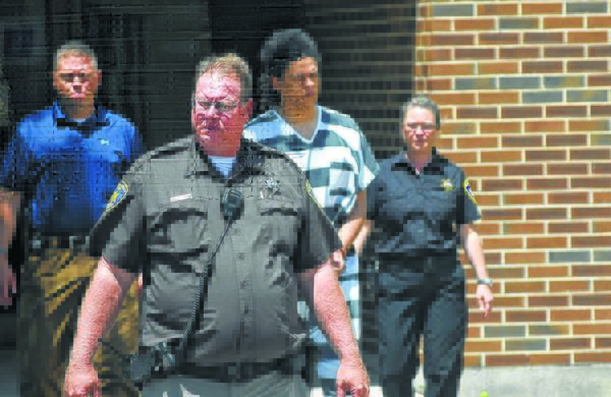 Dustin A. Finlaw of Meredosia is led to a courtroom after his arrest in the stabbing death of a Rushville man. Finlaw was found to have been treated for his mental illness and capable of adequately aiding in his own defense; his attorney has maintained that he remains unfit.