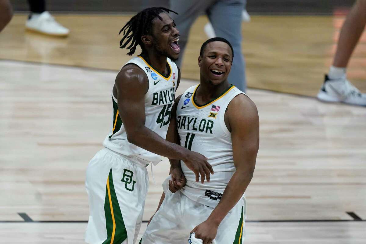 Baylor’s Davion Mitchell (45) and Mark Vital celebrate Monday’s 81-72 victory over Arkansas, which sent the Bears to their first Final Four in 71 years.