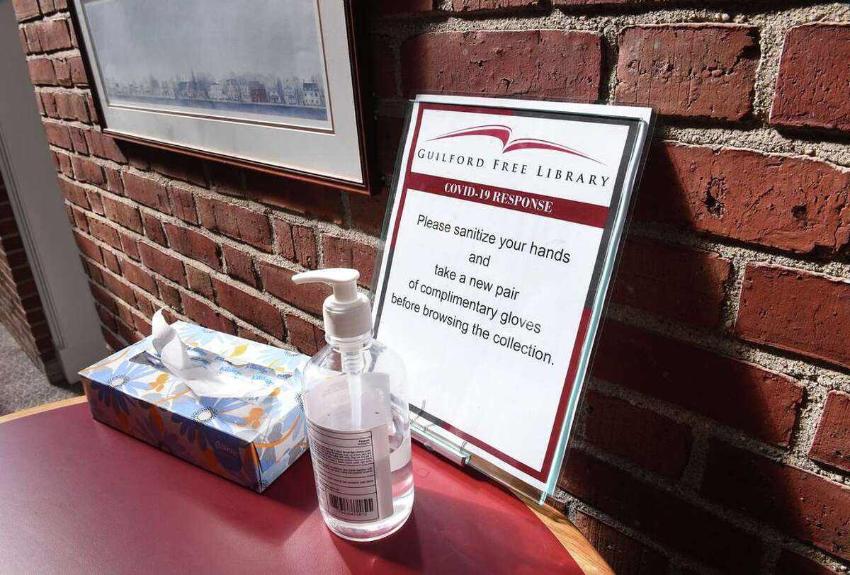 A sign displays instructions during the COVID-19 pandemic at the Guilford Library on March 13.