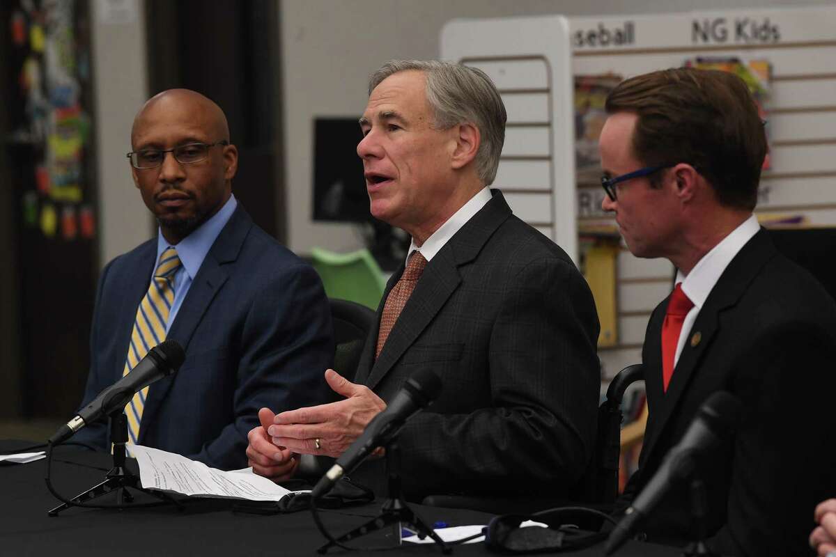 From left, Hamshire-Fannett Superintendent Dwaine Augustine listens as Governor Greg Abbott, House Speaker Dade Phelan and Representative Trent Ashby (out of frame) talk about a new broadband access bill coming before the state legislature during a press conference at Hamshire-Fannett Elementary School Monday. Photo made Monday, March 29, 2021 Kim Brent/The Enterprise