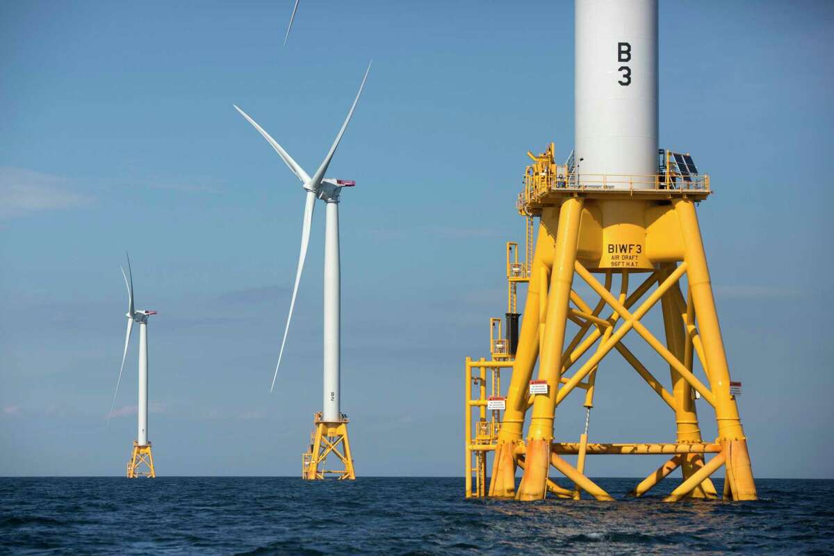 FILE - In this Monday, Aug. 15, 2016, file photo, three of Deepwater Wind's turbines stand in the water off Block Island, R.I. A huge wind farm off the Massachusetts coast is edging closer to federal approval, setting up what the Biden administration hopes will be a model for a sharp increase in offshore wind energy development along the East Coast.(AP Photo/Michael Dwyer, File)