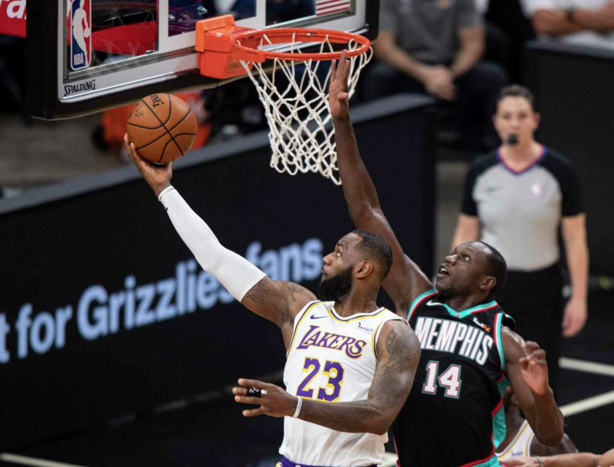 Gorgui Dieng (14), shown blocking LeBron James, has started 205 games in his eight NBA seasons, but he said he’ll be content if he doesn’t add to that total while playing for the Spurs.