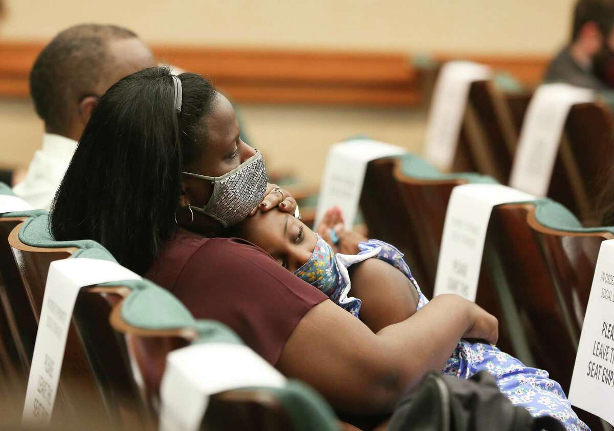 Sharde Butler holds her daughter, Malia, 6, in the overflow room of the Human Services committee of the Texas House hearing for HB3820, which is a direct result of the Houston Chronicle's Do No Harm investigation in Austin on Tuesday, March 30, 2021.
