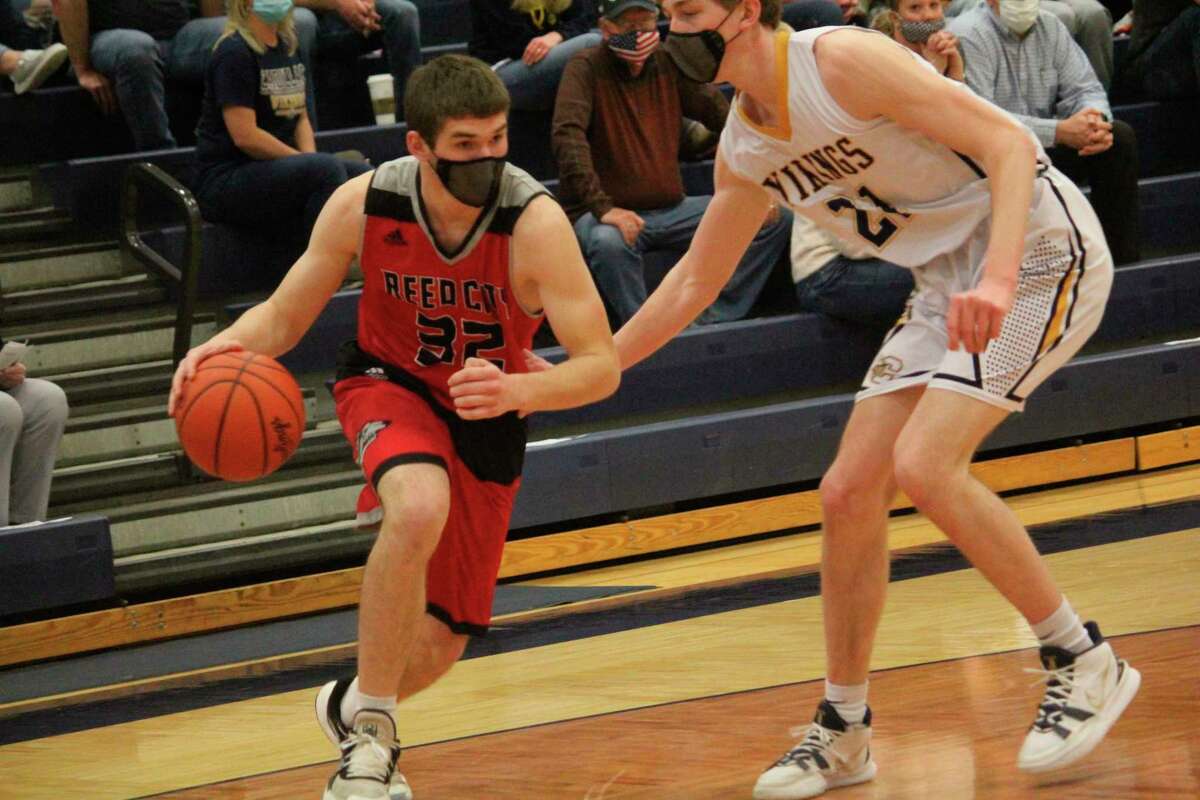 Reed City's Teddy Szymanski (32) drives to the basket against Cadillac in district play on March 23. (Herald Review/John Raffel)